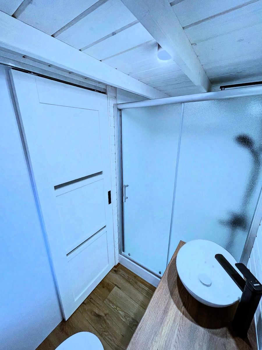 Tiny house bathroom — shower cabin, WC and basin